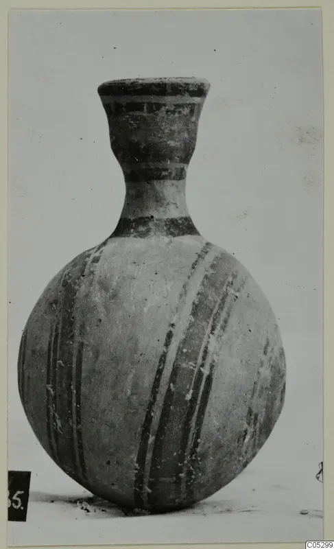 Round-bodied pottery vessel with a tall narrow neck, painted with dark bands and stripes, from Lapithos