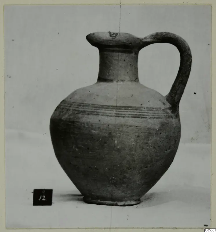White Painted III-1 pottery jug with a single strap handle and thin painted bands on the body