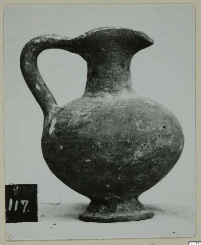 Grey polished ware jug with a strap handle, from the Kastros tombs at Lapithos