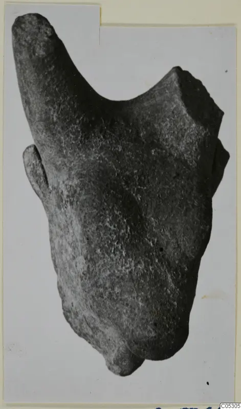 Terracotta fragment, Minor Plastic 1, a worn object with a broken edge, photographed on a card mount