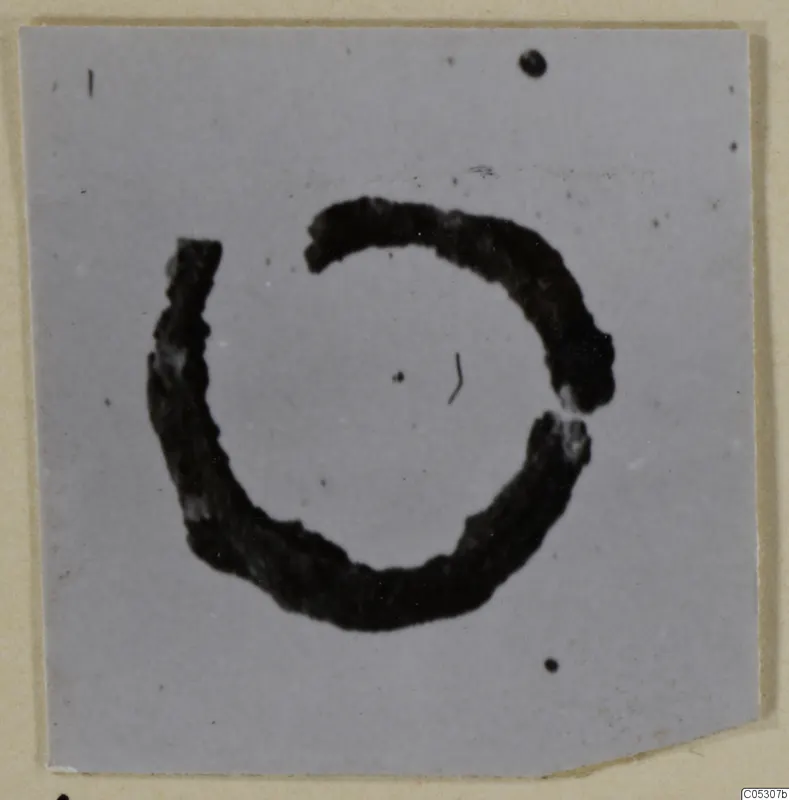 Open ring of bronze personal adornment from the Kastros tombs at Lapithos, photographed on a mount