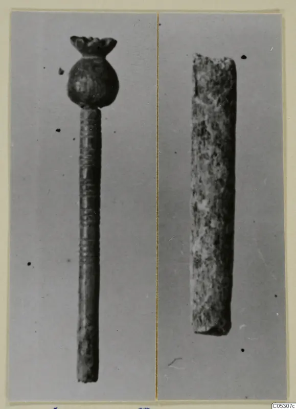Two small find objects from the Kastros tombs at Lapithos: a pin with a knobbed head and grooved shaft, and a short rough rod
