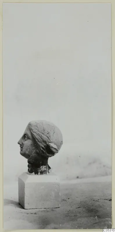 Terracotta female head in profile on a square block base, from Soli