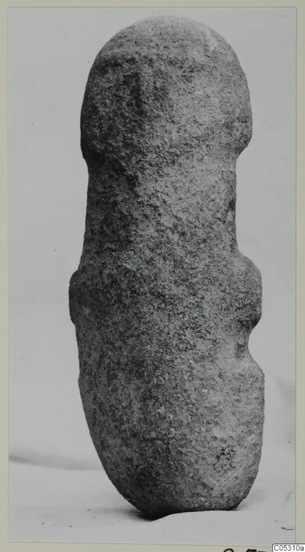 Front view of a stone idol from Petra tou Limniti, standing upright on a pale background.
