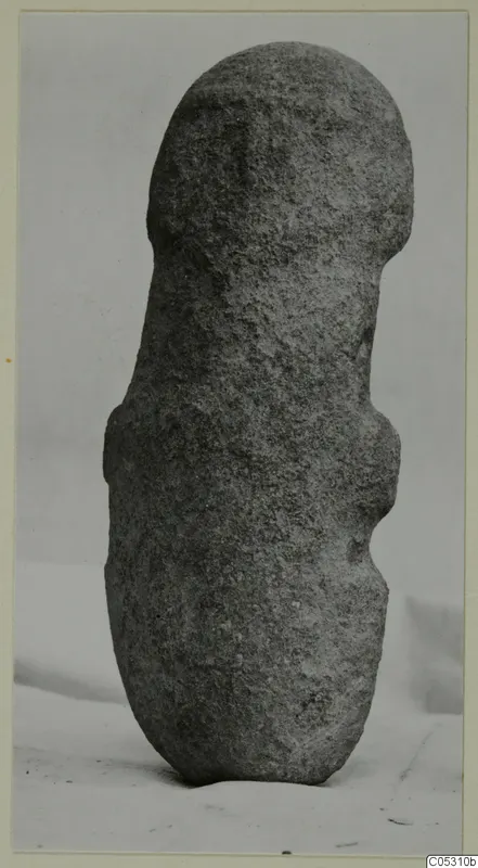Worked stone object from Petra tou Limniti, standing upright on a light cloth