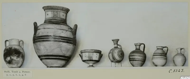 Row of pottery vessels from Stylli, Tomb 9, photographed side by side against a pale background
