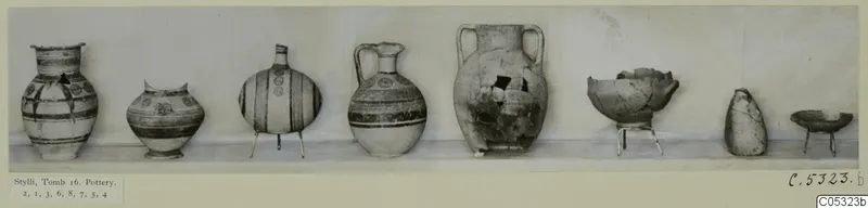 Eight pots from Stylli, Tomb 16, set in a row on a pale shelf against a light wall