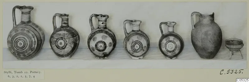 Seven vessels from Tomb 12 at Stylli: five painted jugs with circle motifs, a plain large jug and a small footed bowl.