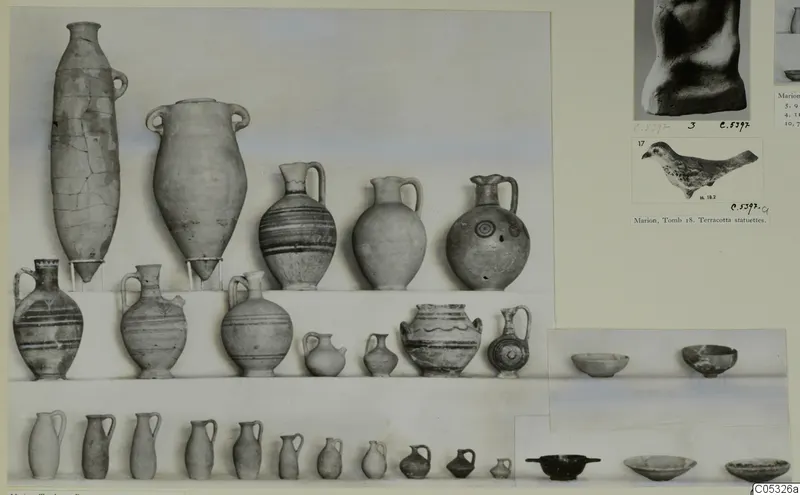 Pottery vessels from Marion, Tomb 20, arranged in rows on a shelf, with painted bands on several, shown on a photo mount.