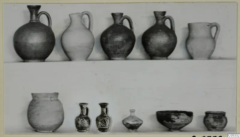 Pottery from Tomb 32 at Marion: jugs, jars, small painted vessels and a bowl arranged on a light background