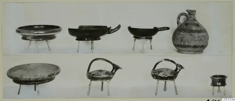 Pottery from Tomb 27 at Marion: shallow bowls on thin stands and a jug, shown in two rows