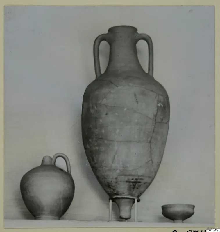 Three pottery vessels from Marion, Tomb 54: a tall two-handled jar, a small jug and a low bowl.