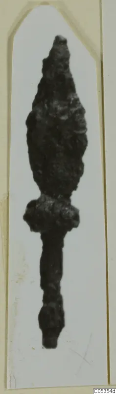 Corroded iron arrowhead with a pointed blade and narrow tang, from the Marion tombs 31–45 finds