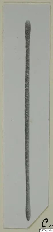 Bronze toilet-requisite from Marion: a long, slender grey rod with rounded ends, shown on a card mount