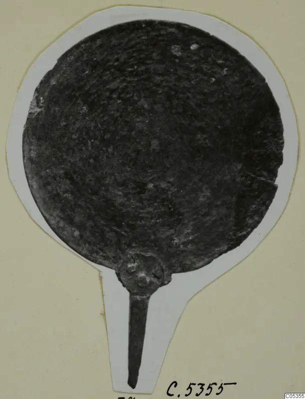 Round metal disc with a short tang handle, photographed on a white card mount, plate from Marion