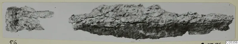 Two corroded iron fragments on a grey background, mounted on a cream card, from Amathus