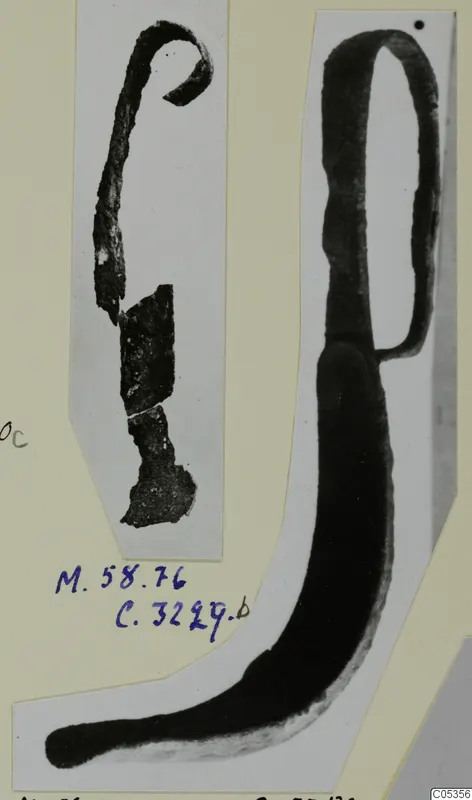 Two bronze toilet requisites from Marion, one a long curved implement with a loop at the top, mounted on a card.
