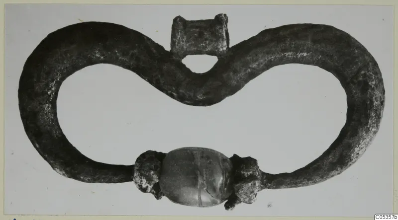 Silver pendant from Marion: a figure-eight loop of metal with a central oval bead at the bottom