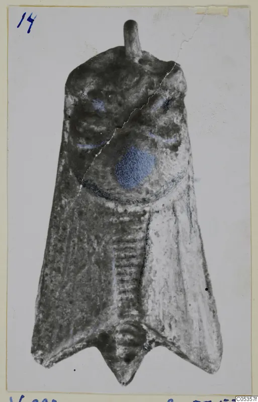 Silver-coloured metal object from Vouni, flat and tapering, with a loop at the top and blue-painted patches on the upper part.