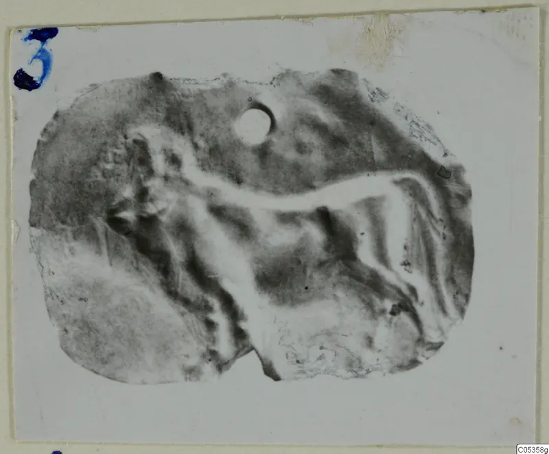 Fragment of a gold jewellery piece from Vouni, with a raised figure in relief and a small round hole