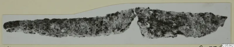 Corroded metal object broken into two pieces, photographed on a mounted card, from Amathus