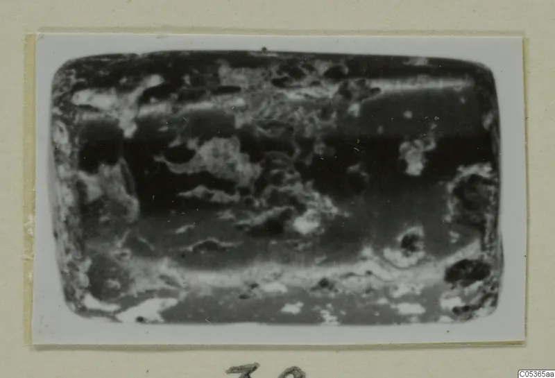 Small rectangular object with rounded corners and an encrusted, pitted surface, from Amathus