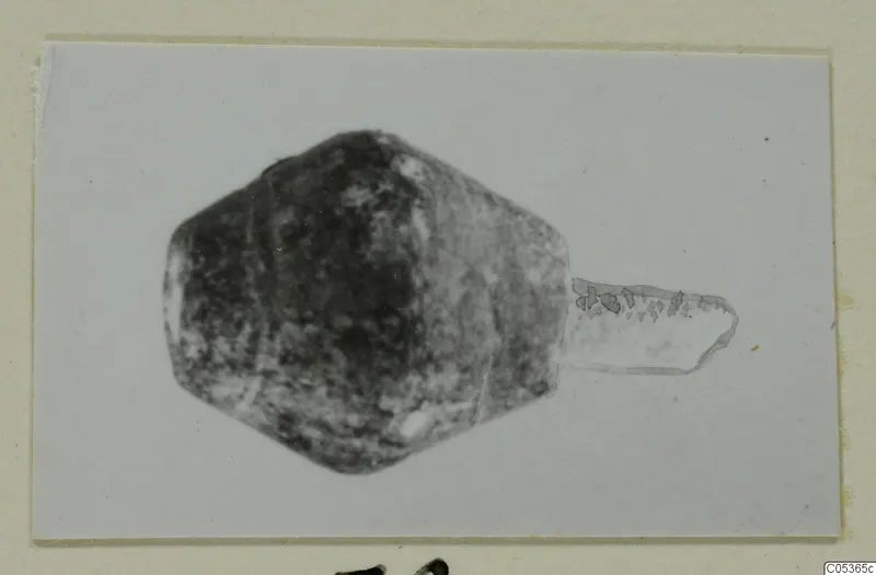 Find from Amathus: a dark angular object with a pale part projecting to one side.
