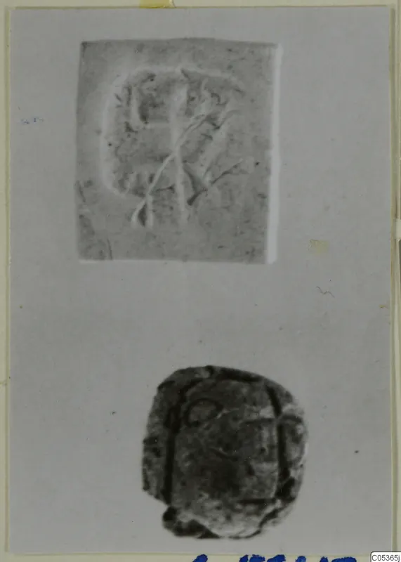 Seal impression above a dark stone seal, laid out on a grey card.