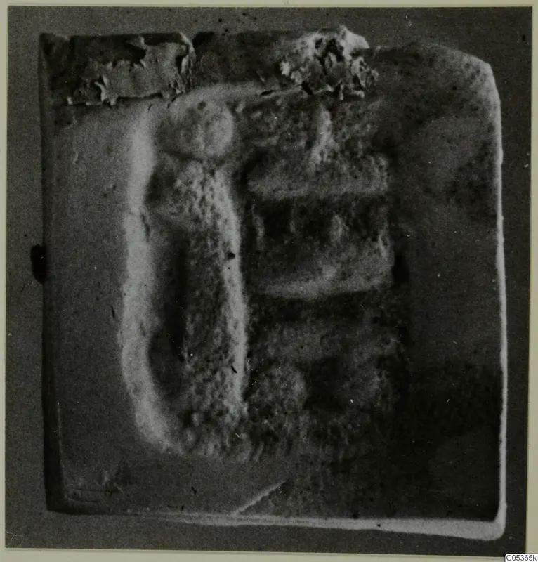 Seal or gem with a raised relief design, photographed on a grey ground