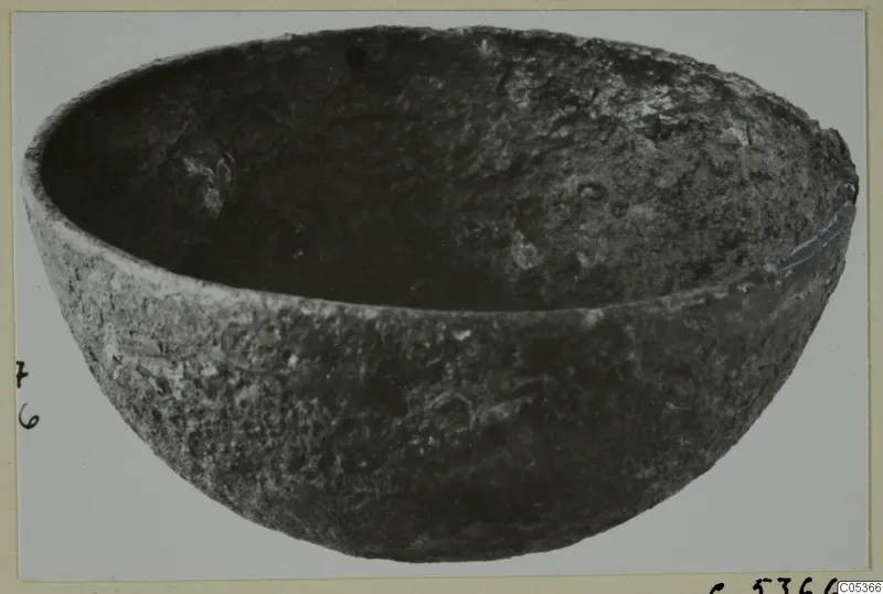 Deep rounded bowl with a rough, pitted dark surface, from Amathus