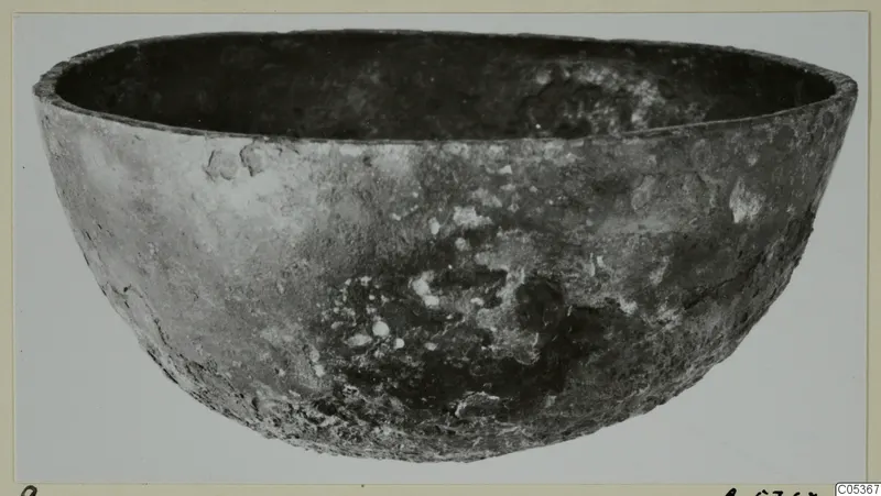 Bowl from Amathus, a deep rounded bowl with a corroded, pitted surface, photographed against a plain background.