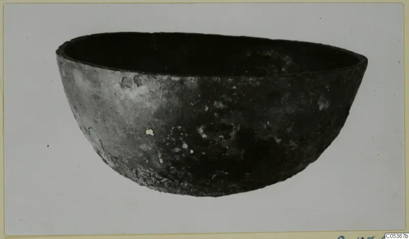 Dark, rounded bowl with a wide open rim, shown on a plain background