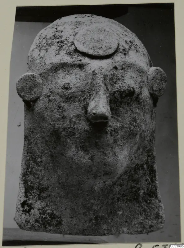 Stone head from Amathus with a broad face, large nose, round ears and a disc on the crown.