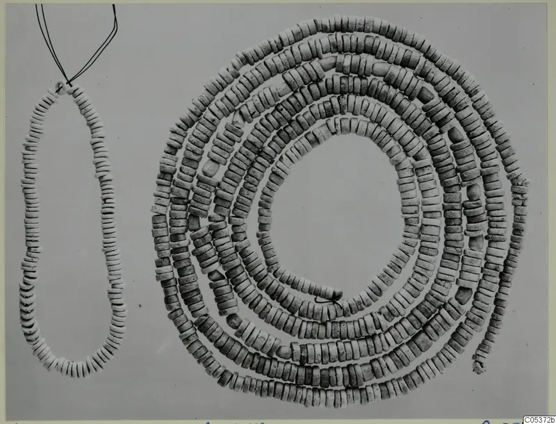 Pale disc beads: a short necklace with wire ends at left, and a coiled multi-strand bead set at right, from Amathus