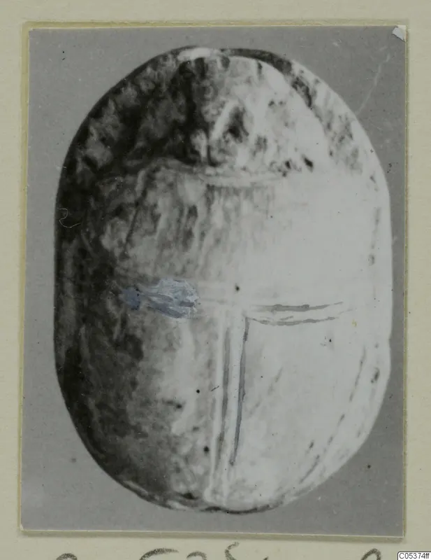 Oval object from Amathus with incised lines on its flat base, mounted on a card.