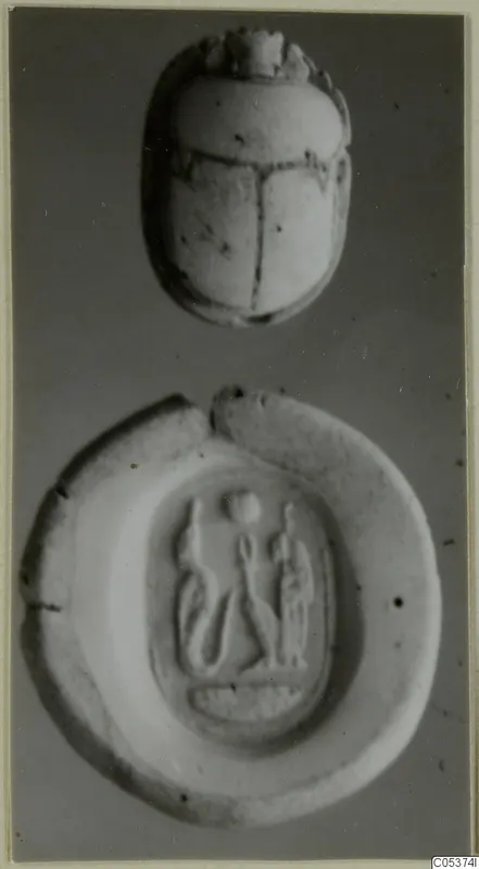 Scarab seal above a flat oval stone seal with three figures carved in relief in a recessed panel
