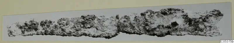 Corroded iron tool from Amathus, a long narrow fragment with a break near the middle