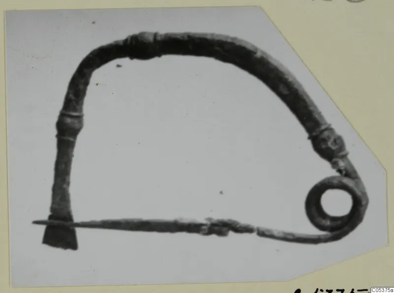 Bronze object from Amathus with an arched bow and a coiled spring at one end
