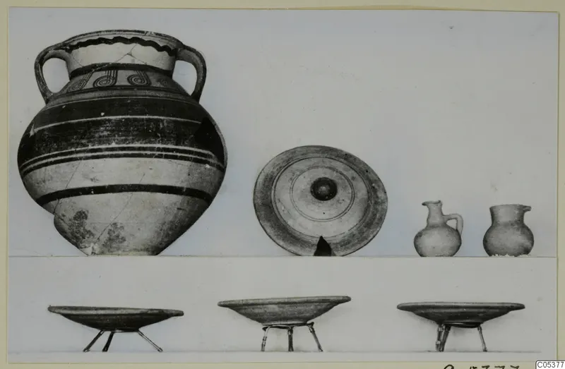 Pottery from Amathus, Tomb 3: a large two-handled jar, a dish, two small jugs and three bowls on metal stands.