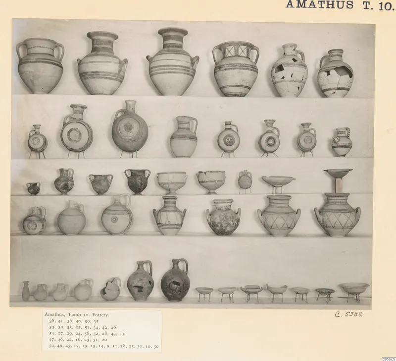 Rows of pottery vessels from Amathus, arranged on tiers against a pale backdrop, shown in a photo mount