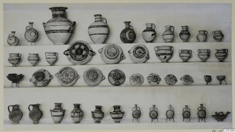 Pottery vessels from Tomb 22 at Amathus, arranged in four rows on a pale background