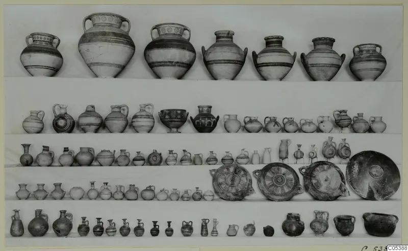 Five rows of pottery vessels from Amathus, Tomb 16: jars, jugs, juglets, bowls and large plates