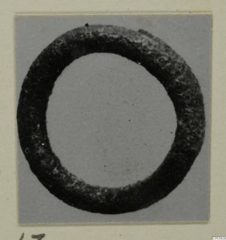 Silver ring with a thick, dark, pitted band, from Amathus