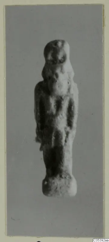 Small standing figurine from Amathus, photographed upright against a plain grey background.