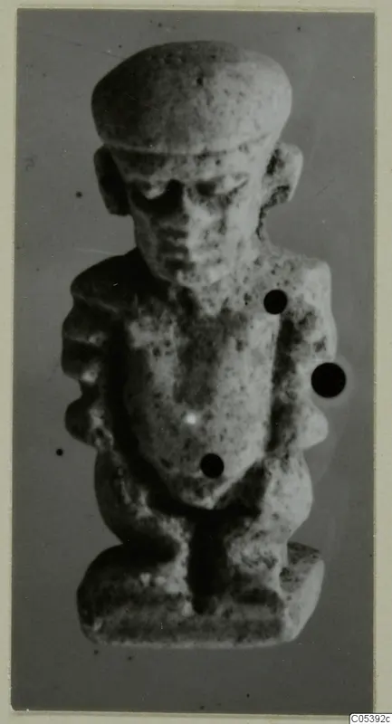 Small stone figure with a flat-topped head, bent arms and a rectangular base, from Pateke, Amathus series