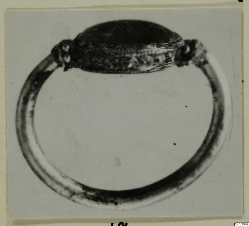 Ring with a broad oval bezel from Marion, photographed on a card mount