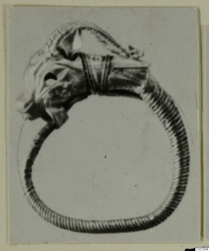 Figurine and ring from Marion: a hoop ring with a small figure projecting from its top
