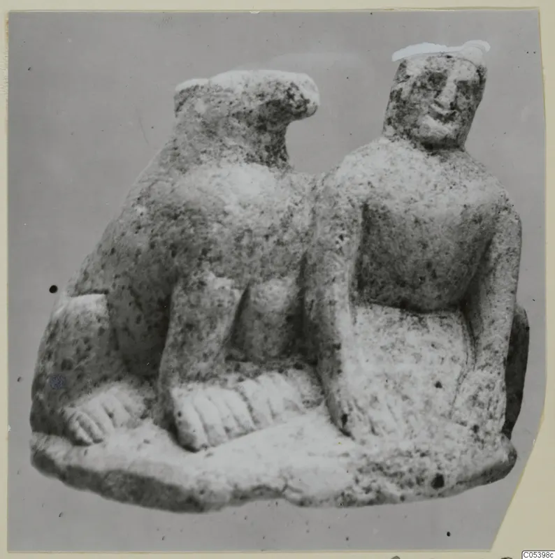 Limestone statuette of two figures side by side on a shared base