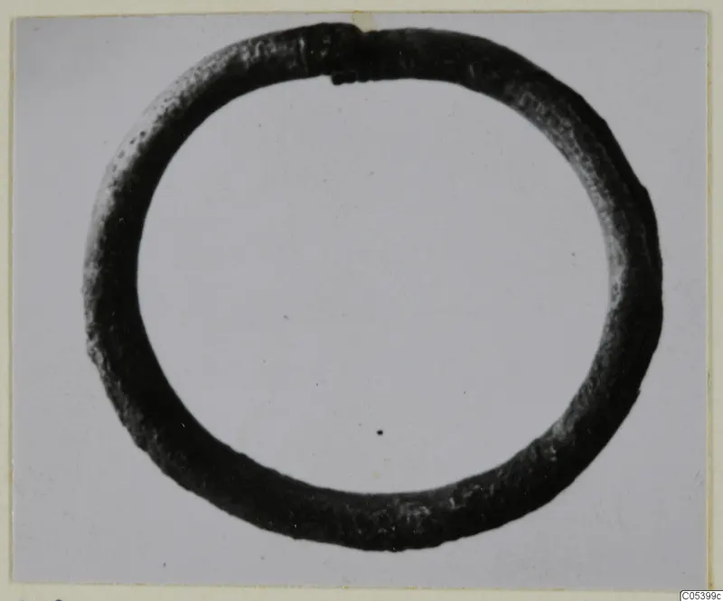 Silver bracelet, a plain closed ring of dark metal shown against a light background.