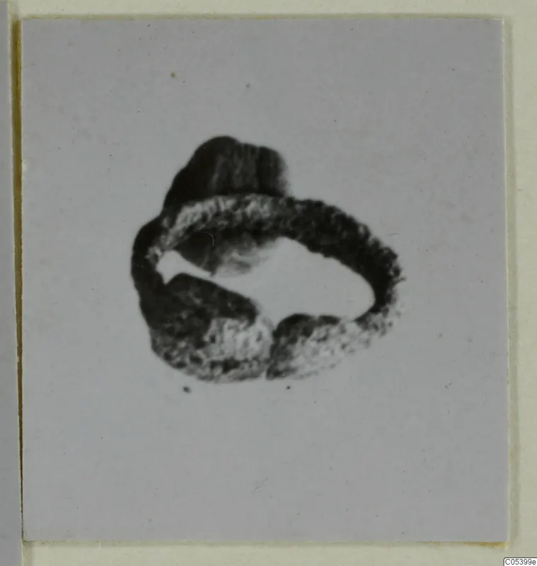Silver ring-shaped find, thick band with a lump on top and a break on one side